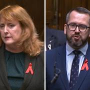 SNP MPs Deidre Brock and Stewart McDonald wearing red ribbons while speaking in the Commons