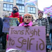 People take part in a demonstration for trans rights outside the UK Government Office at Queen Elizabeth House in Edinburgh