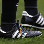 An official wearing boot laces supporting Stonewall's Rainbow Laces campaign