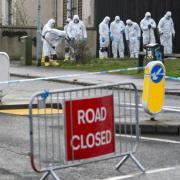 Forensic officers on the scene of a shooting on Hogmanay