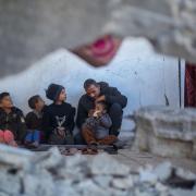 Palestinian Mahmoud Al-Durra who was displaced to the city of Rafah in the south of the Gaza Strip after Israeli raids destroyed his house and his wife was killed, lives on the rubble of a destroyed house and cares for his four children