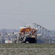 A container ship rests against wreckage of the Francis Scott Key Bridge