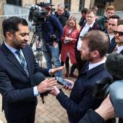 Outgoing First Minister Humza Yousaf speaks to the media during a visit to a housing development on April 26