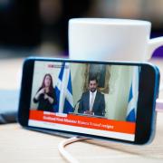 A phone shows BBC News broadcasting Humza Yousaf's resignation speech