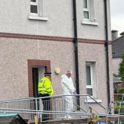 Police taped off the street after a man died following a 'disturbance' in Glasgow
