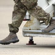 A member of the British armed forces disembarks from an RAF aircraft
