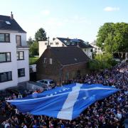 The Tartan Army walk past St. Vitalis church in Cologne during an organised walk to the stadium before the UEFA Euro 2024 Group A match at the Cologne Stadium
