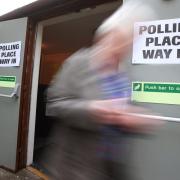 A voter leaves Broomhouse Community Hall polling station in Glasgow after casting their vote for the local council elections.