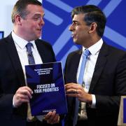 Scottish Conservative leader Douglas Ross and British Prime Minister Rishi Sunak pose with a copy of The Scottish Conservative and Unionist Party Manifesto