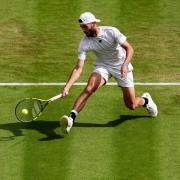 Jacob Fearnley in action against Novak Djokovic