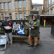 SNP and Labour activists outside the polling station at Pollokshields primary school in the Southside of Glasgow