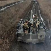 Russian Army soldiers ride their armoured toward positions at an undisclosed location in Ukraine