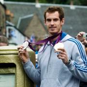 Andy Murray poses with his gold post box as he returns to Dunblane after recently being crowned US Open champion and winning gold and silver medals at the London 2012 Olympic Games  