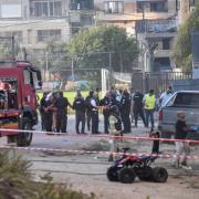 Israeli police officers and firefighters work at the site of a rocket attack in Majdal Shams, in the Israeli-controlled Golan Heights