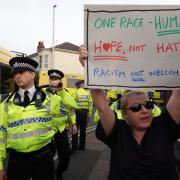 A woman was spotted holding up a 'hope not hate' sign in the middle of a violent riot in Southport