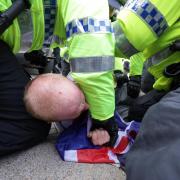 Police restrain a man during a far-right protest in Liverpool