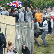 Far-right rioters clash with police outside a Holiday Express in Manvers