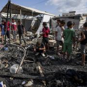 Palestinians inspect the damage at a tent area in the courtyard of Al Aqsa Martyrs hospital, hit by an Israeli bombardment on Deir al-Balah, Sunday, August 4, 2024