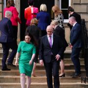 SNP First Minister John Swinney (front right) and Deputy First Minister Kate Forbes walk to speak to media as the rest of the Cabinet heads in Bute House