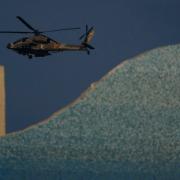 An Israeli Apache helicopter flies over an area in Israel