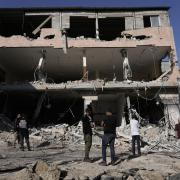 People look at destruction after an Israeli army raid on a Palestinian refugee camp, Nur Shams, in the West Bank last year