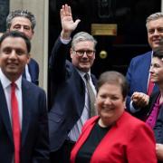 Keir Starmer waves as Scottish Labour MPs and MSPs attend a photocall outside Downing Street