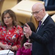 The First Minister John Swinney in the Scottish Parliament