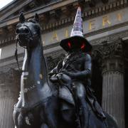 The Duke of Wellington statue with a traffic cone on its head outside Goma, Glasgow City centre.  Photograph by Colin Mearns