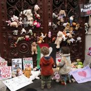 Parents and children lay out cuddly toys across the entrance to the Foreign Office in London, as they protest to save children's lives in Gaza