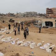 Bodies lined up for identification after they were unearthed from a mass grave found in the Nasser Medical Complex in the southern Gaza Strip