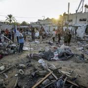 Palestinians inspect damage in the courtyard of Al Aqsa Martyrs hospital