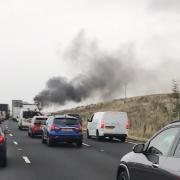 Photo of traffic and a plume of black smoke from the fatal crash on the M6