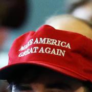 A person wears a Make America Great Again cap