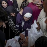 Palestinians mourn their relatives killed in the Israeli bombardment of the Gaza Strip at a hospital morgue in Deir al-Balah, Friday, Nov. 1, 2024. (AP Photo/Abdel Kareem Hana).