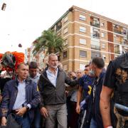 King Felipe VI of Spain (C) is heckled by angry residents who throw mud and objects during his visit to Paiporta