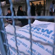 A Palestinian woman waiting for aid hand outs from UNRWA in 2014