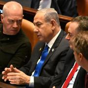 Israeli Prime Minister Benjamin Netanyahu (centre) has dismissed defence minister Yoav Gallant (left)