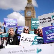 Campaigners in support of voluntary euthanasia protest outside Parliament in Westminster, London