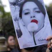 Demonstrators hold placards outside the Iranian Embassy in London