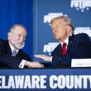 Mike Huckabee speaks with Donald Trump at a community roundtable