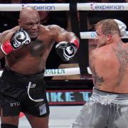 Mike Tyson, left, fights Jake Paul during their heavyweight boxing match in Arlington, Texas (Julio Cortez/AP)