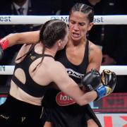 Amanda Serrano, right, and Katie Taylor fight during their undisputed super lightweight title bout on Friday (Julio Cortez/AP)