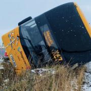 A Stagecoach bus toppled on its side amid icy conditions