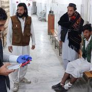 An injured victim awaits hospital treatment (Dilawar Hussain/AP)