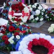 Wreaths are laid during a memorial service at 1000 Trades Square, outside New Street station in Birmingham to mark the 50th anniversary of Birmingham pub bombings (PA)