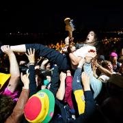 A guitarist from Idles in the crowd while playing during Glastonbury Festival this summer