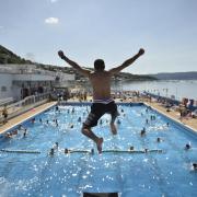 A swimmer leaps into the heated water of Gourock Pool in Inverclyde