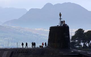 A trident submarine makes it's way out from Faslane Naval base