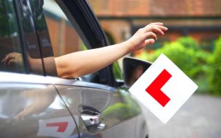 Throwing the L plates out of the car window in celebration having just passed her test.