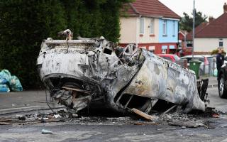 The car that was set alight in Ely, Cardiff, following the riot that broke out after two teenagers died in a crash